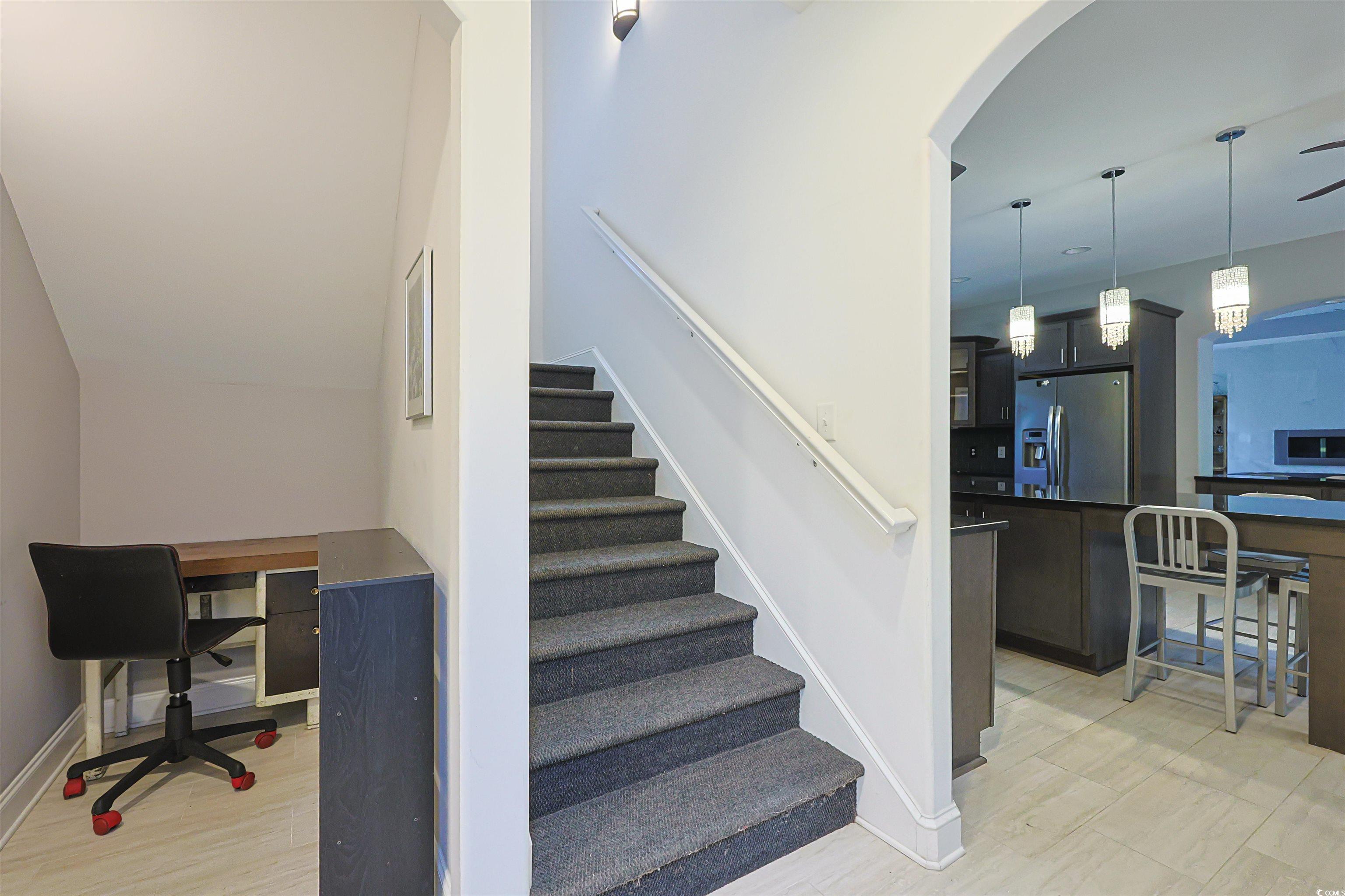 1065 Wigeon Drive Conway, SC 29526 - Photo 14 of 40 Stairway with wood finished floors and arched walkways