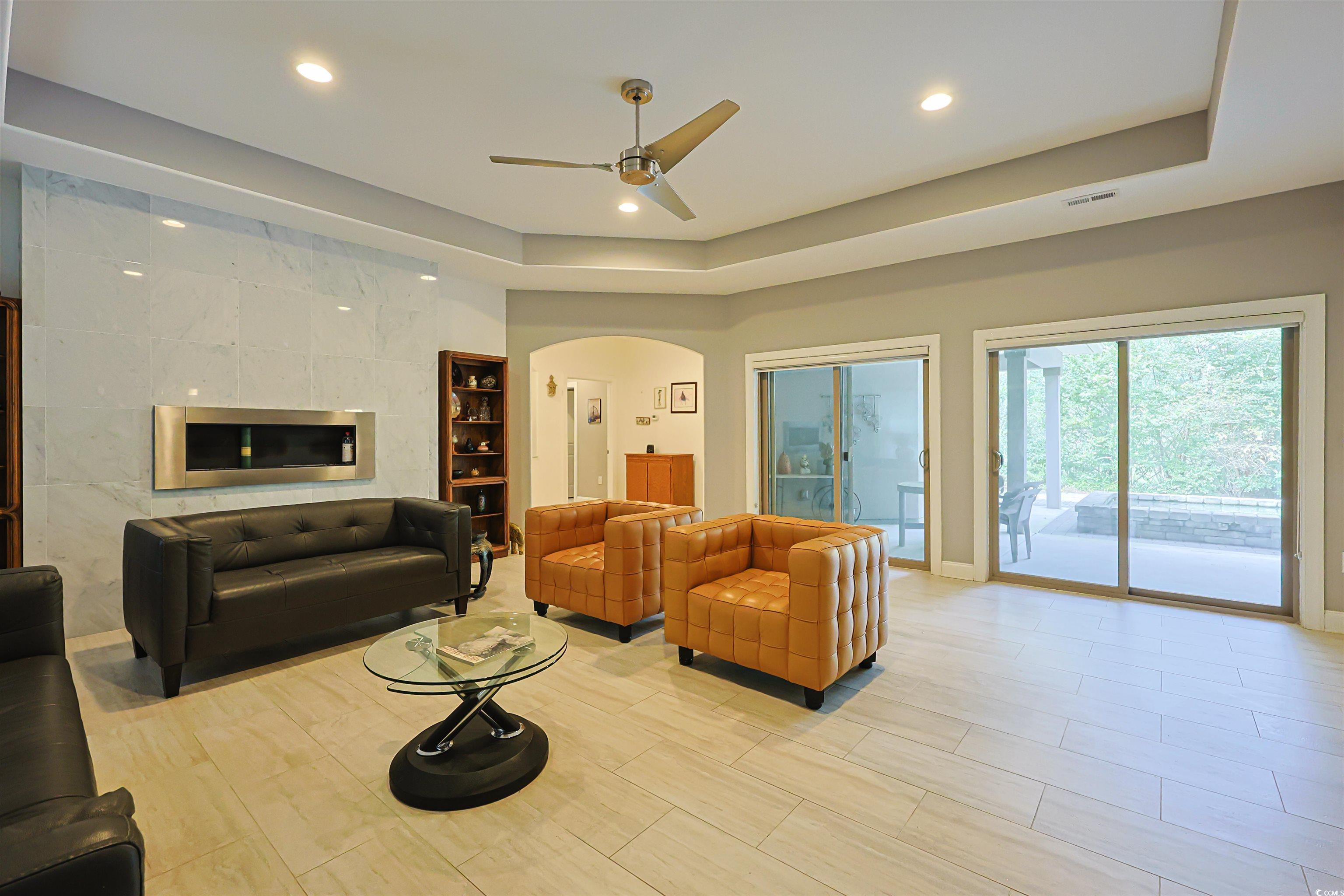 1065 Wigeon Drive Conway, SC 29526 - Photo 3 of 40 Living area featuring a tray ceiling, arched walkways, ceiling fan, recessed lighting, and light wood-style flooring