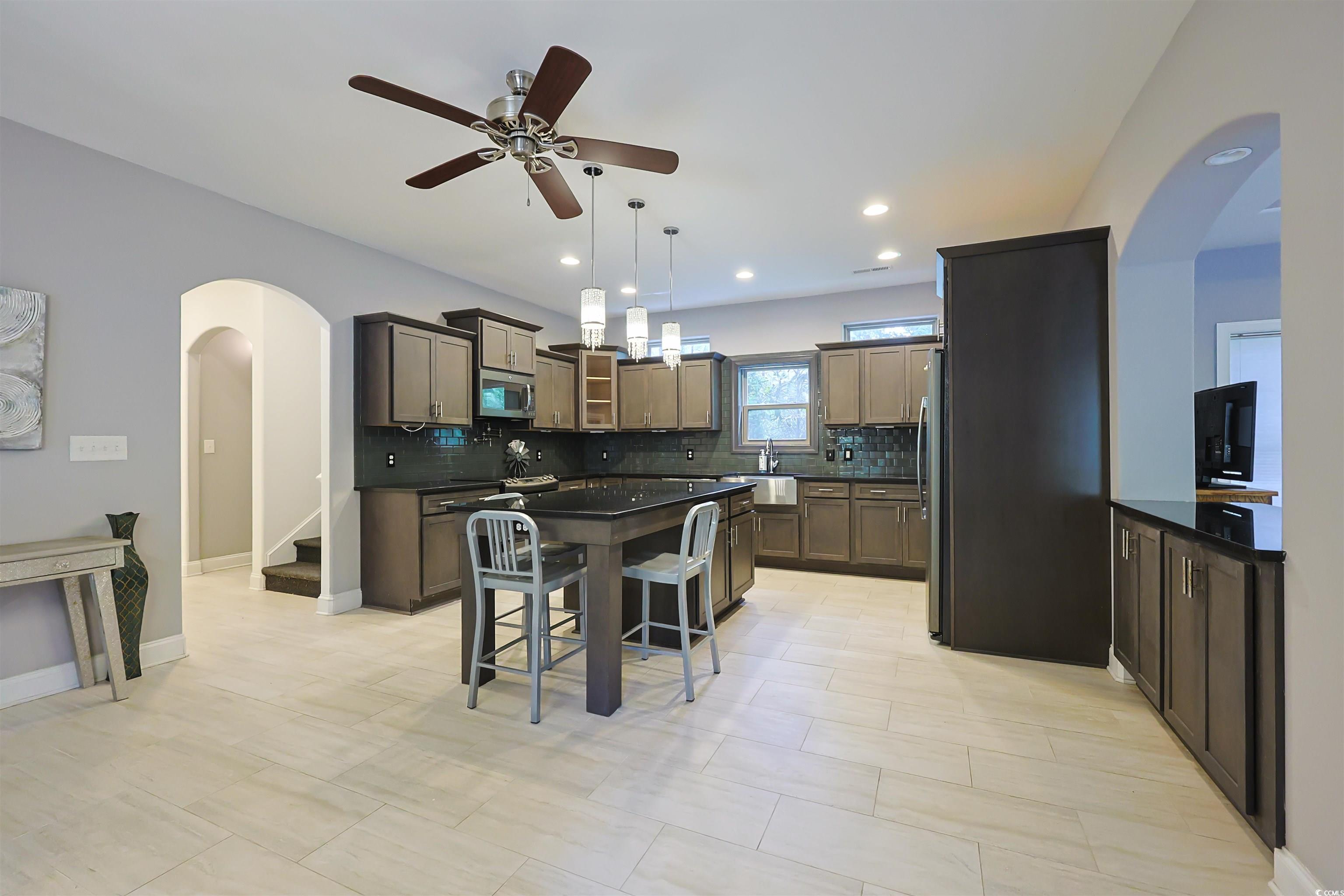 1065 Wigeon Drive Conway, SC 29526 - Photo 5 of 40 Kitchen with arched walkways, a kitchen breakfast bar, a center island, backsplash, and decorative light fixtures