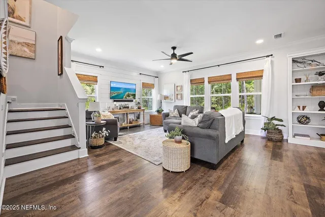 a living room with furniture and large windows