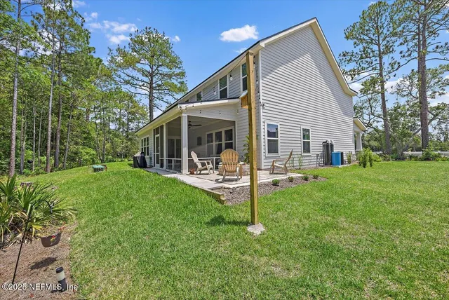 a view of a house with backyard porch and sitting area