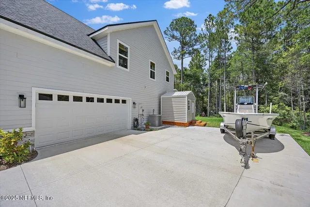 a backyard of a house with outdoor seating and barbeque oven