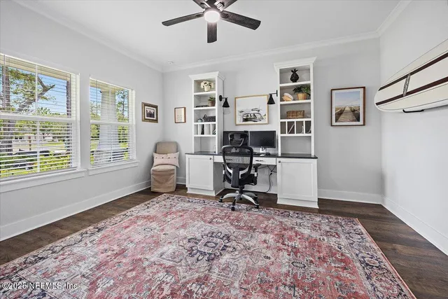 a view of a workspace with furniture and a window