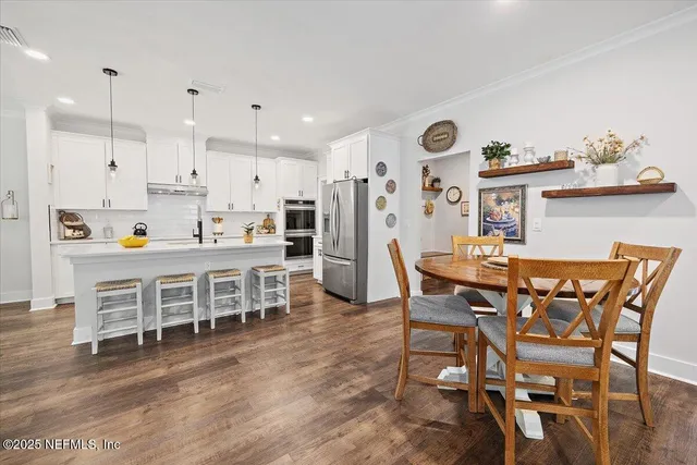 a dining room with furniture and wooden floor