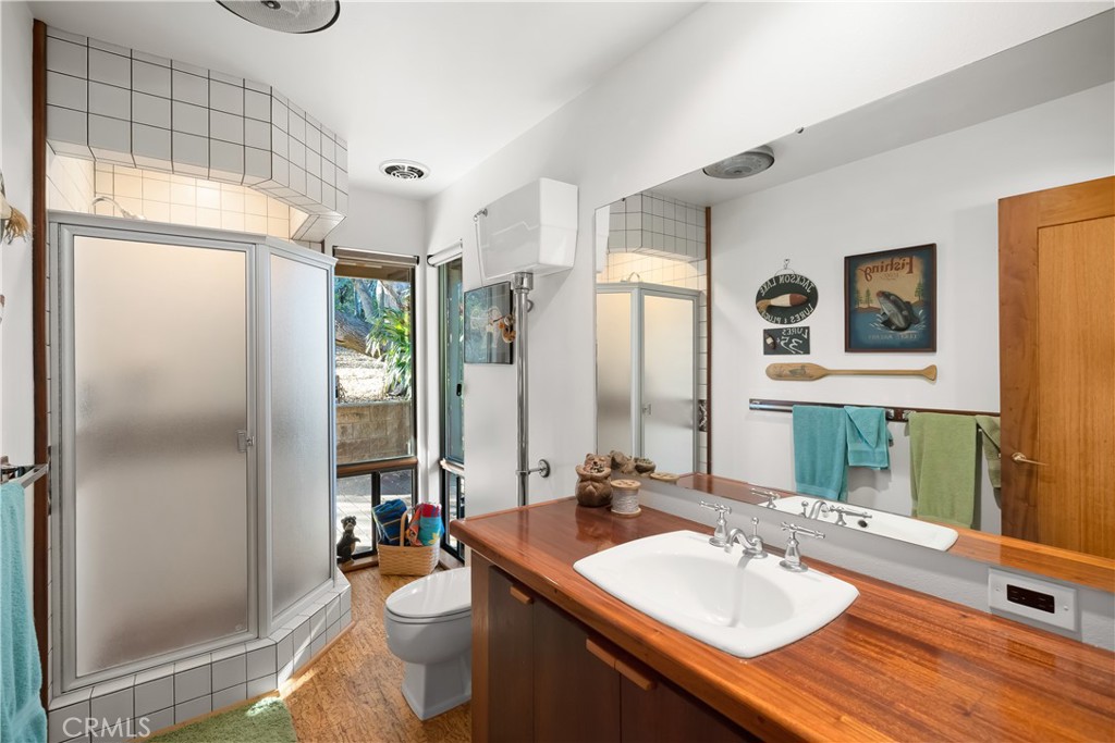 4411 See Canyon Road San Luis Obispo, CA 93405 - Photo 24 of 75 a bathroom with a sink a toilet and a mirror
