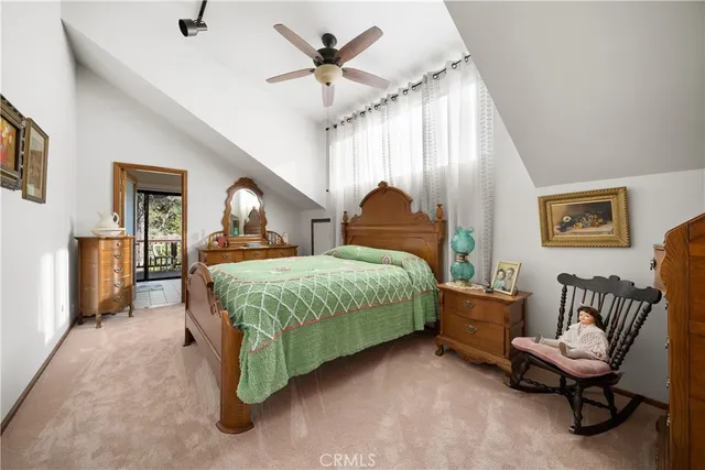 a view of a patio with a table and chairs under an umbrella with a barbeque