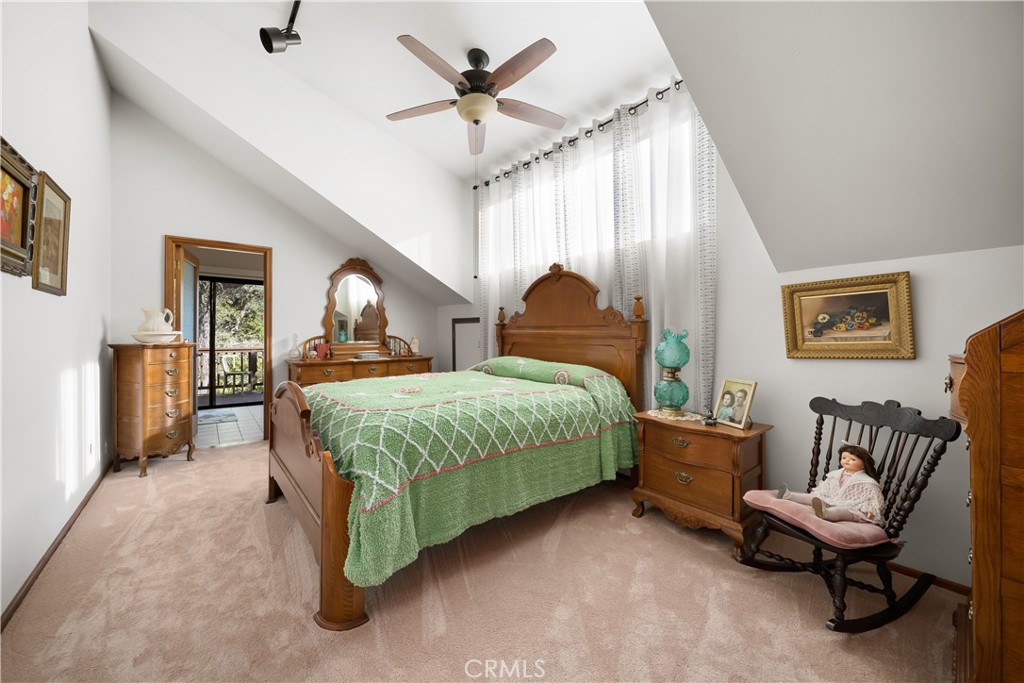4411 See Canyon Road San Luis Obispo, CA 93405 - Photo 25 of 75 a spacious bedroom with a bed and a chandelier