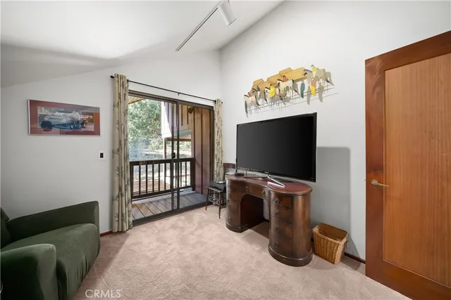 a spacious bedroom with a bed and a large window