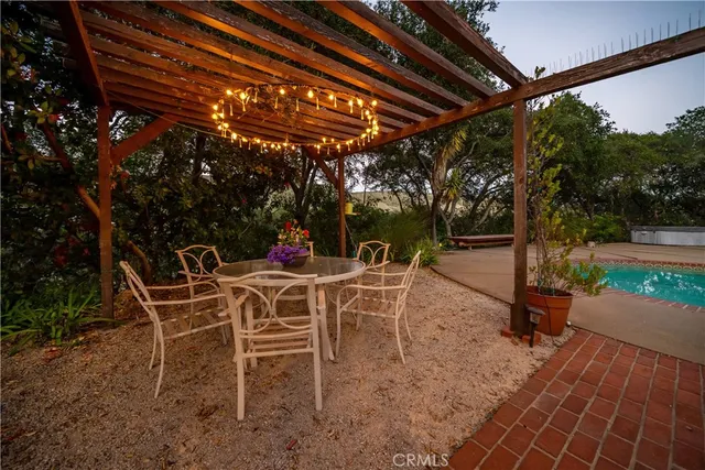 a view of a patio with a table chairs and a couple of flower garden