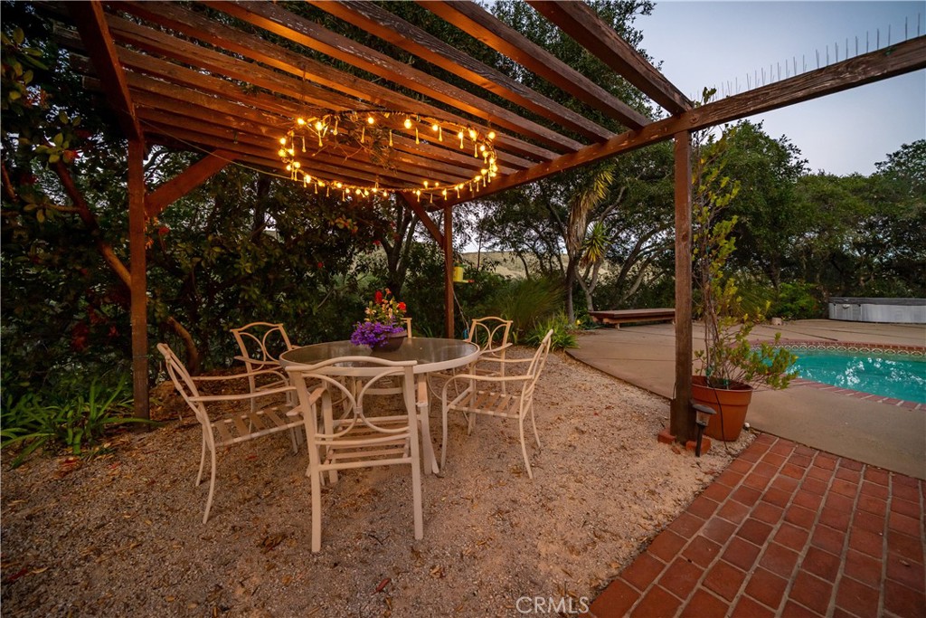 4411 See Canyon Road San Luis Obispo, CA 93405 - Photo 41 of 75 a view of a patio with a table and chairs under an umbrella with a barbeque