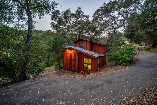 an aerial view of a house with a mountain