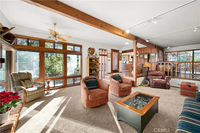 a living room with furniture a rug and a large window