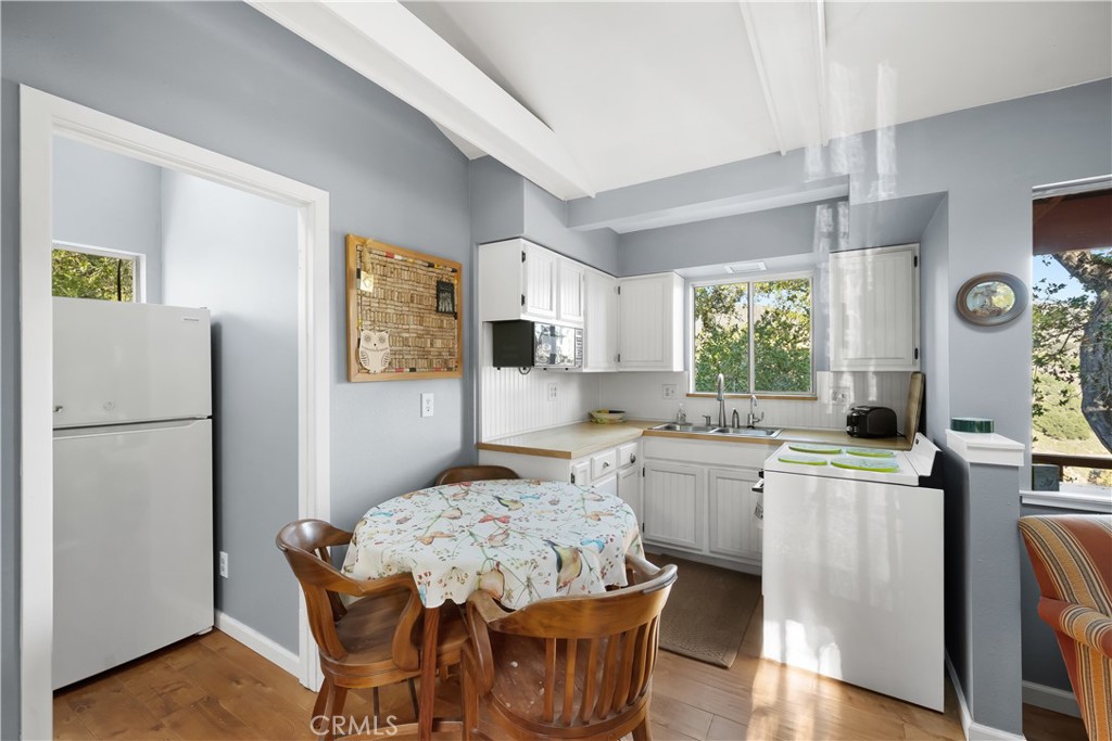 4411 See Canyon Road San Luis Obispo, CA 93405 - Photo 51 of 75 a kitchen with a stove a refrigerator and a dining table