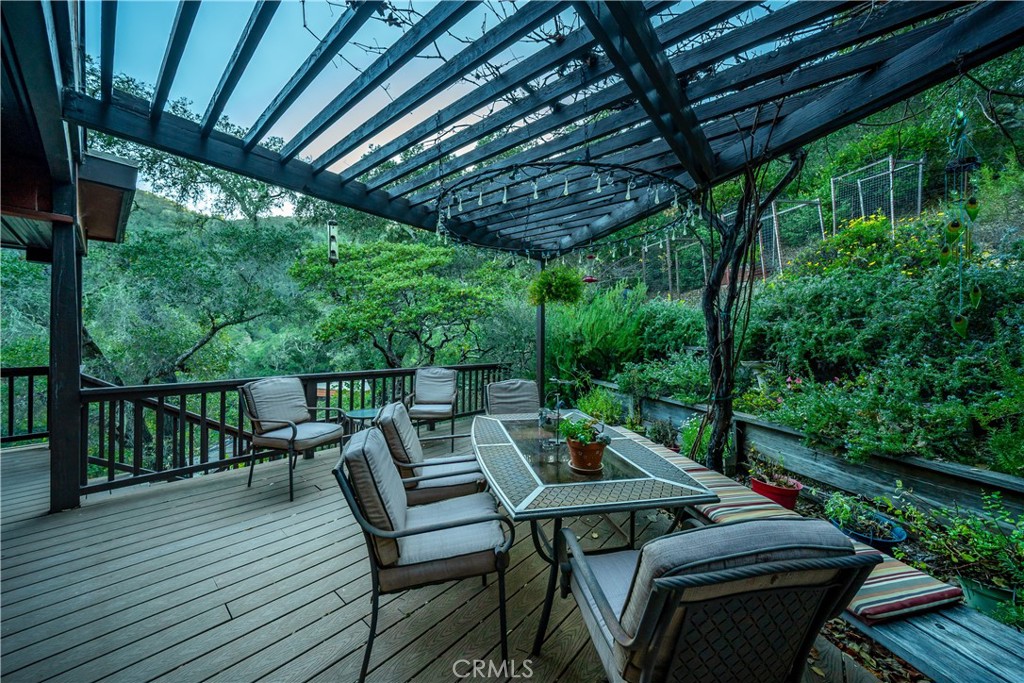 4411 See Canyon Road San Luis Obispo, CA 93405 - Photo 62 of 75 a view of a patio with a table chairs and a couple of flower garden