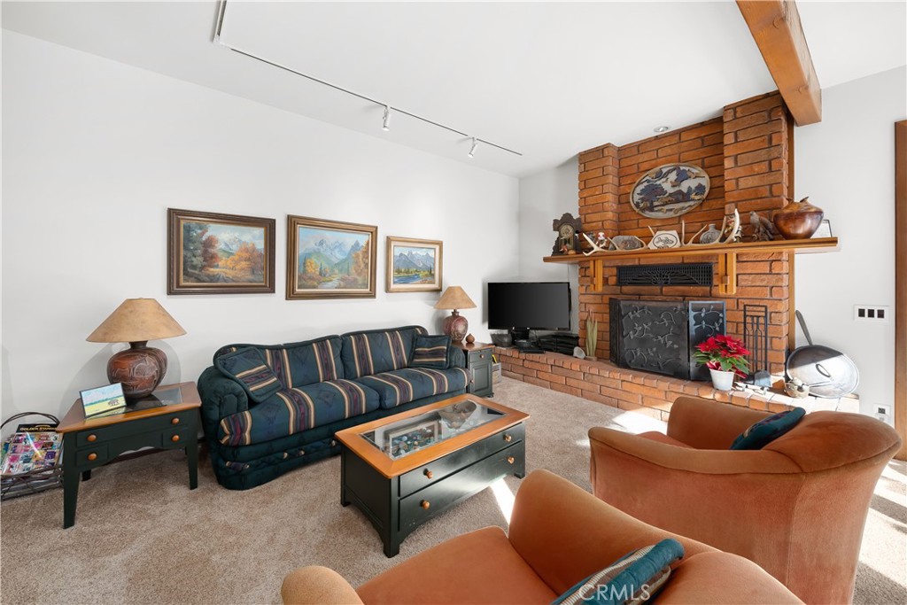4411 See Canyon Road San Luis Obispo, CA 93405 - Photo 8 of 75 a living room with furniture a fireplace and a flat screen tv