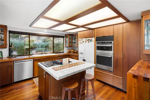 a kitchen with a stove a refrigerator and a table