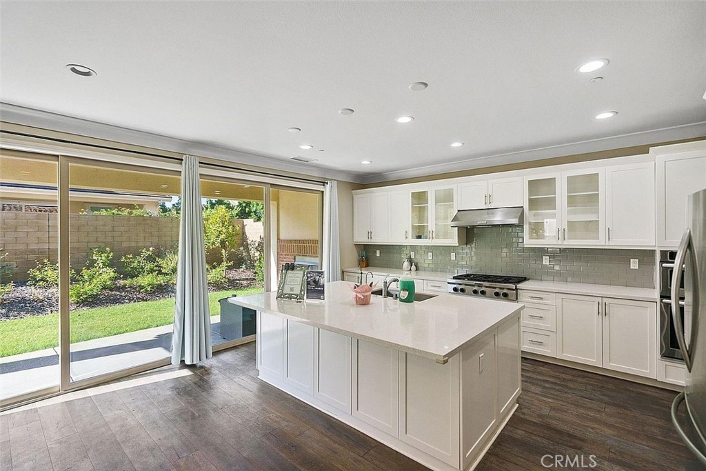 217 Compass Irvine, CA 92618 - Photo 11 of 34 a kitchen with a stove a sink a refrigerator and a view of kitchen
