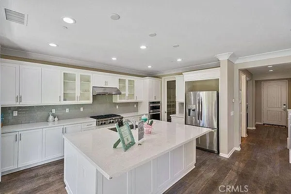 a kitchen with stainless steel appliances a stove a sink and a refrigerator