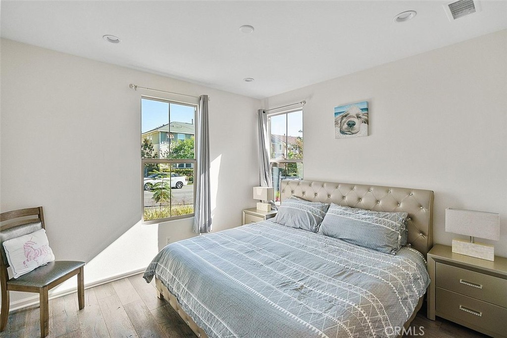 217 Compass Irvine, CA 92618 - Photo 23 of 34 a bedroom with a bed and wooden floor