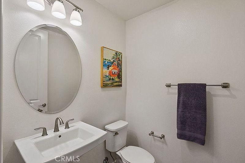 217 Compass Irvine, CA 92618 - Photo 24 of 34 a bathroom with a toilet sink and mirror