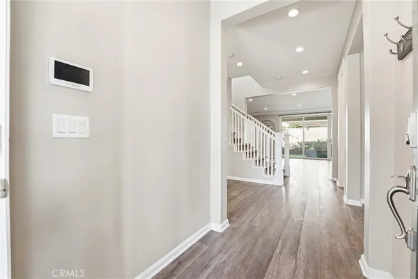 a large white kitchen with wooden floor and floors