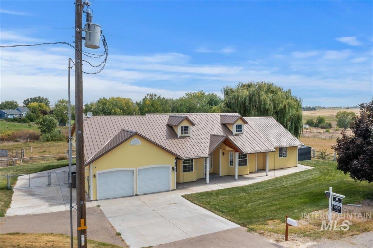 7900 Labor Camp Road Caldwell, ID 83607 - Photo 39 of 45 Expansive property featuring a metal outbuilding with multiple bay doors, a covered patio, and a separate storage shed