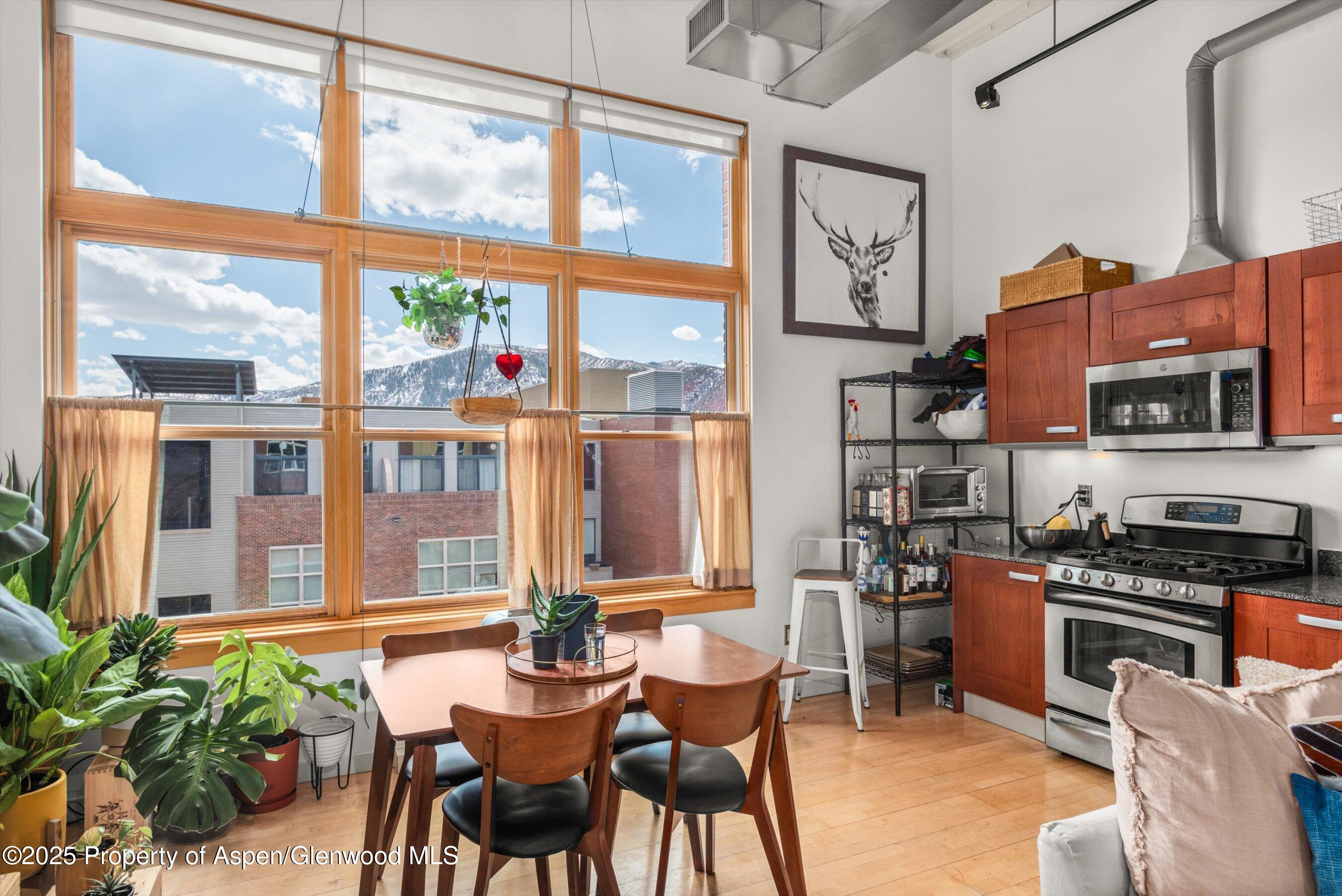 231 Robinson Street, Unit 338 Basalt, CO 81621 - Photo 11 of 17 a view of a dining room with furniture window and wooden floor