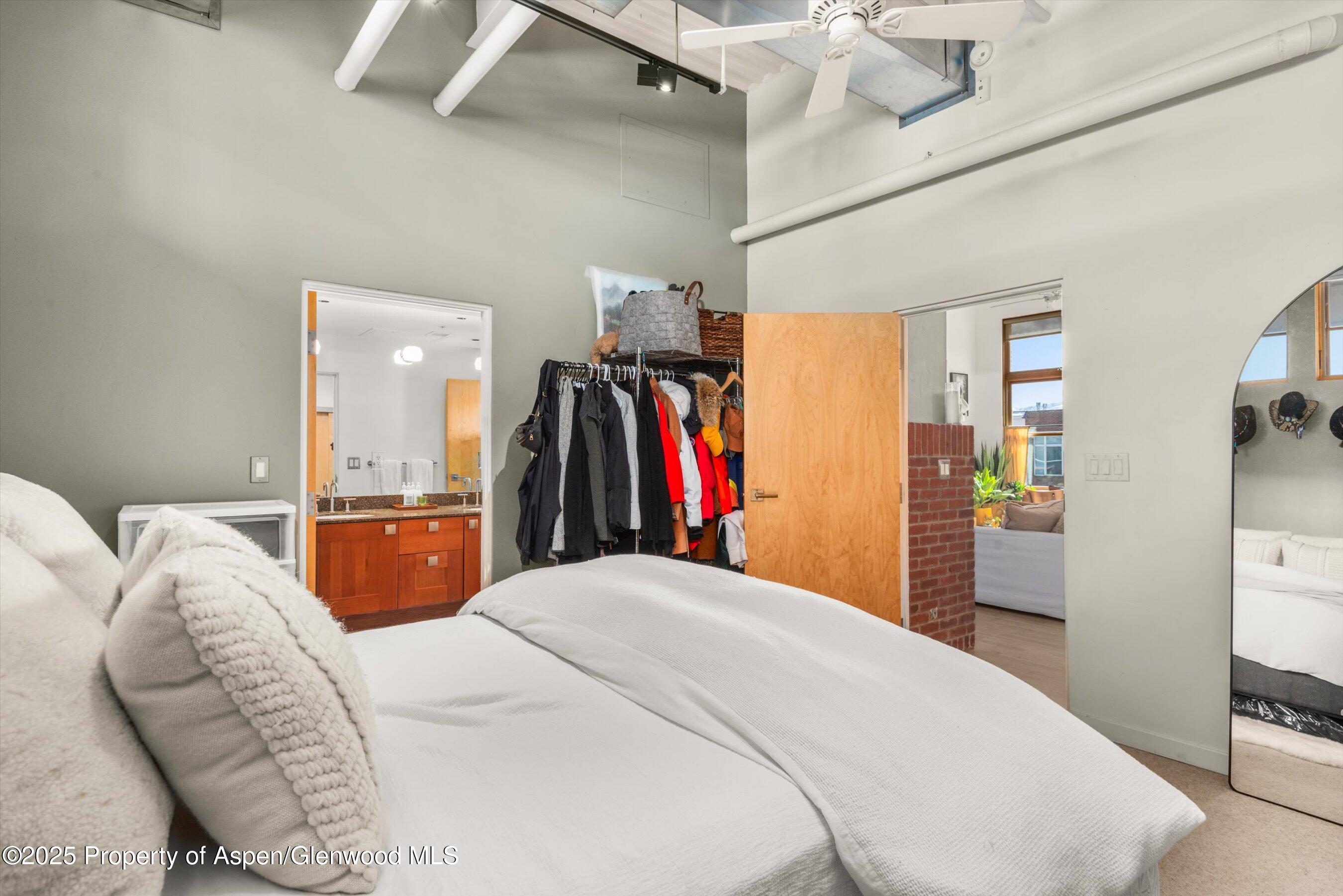 231 Robinson Street, Unit 338 Basalt, CO 81621 - Photo 13 of 17 a bed room with a bed and a walk in closet