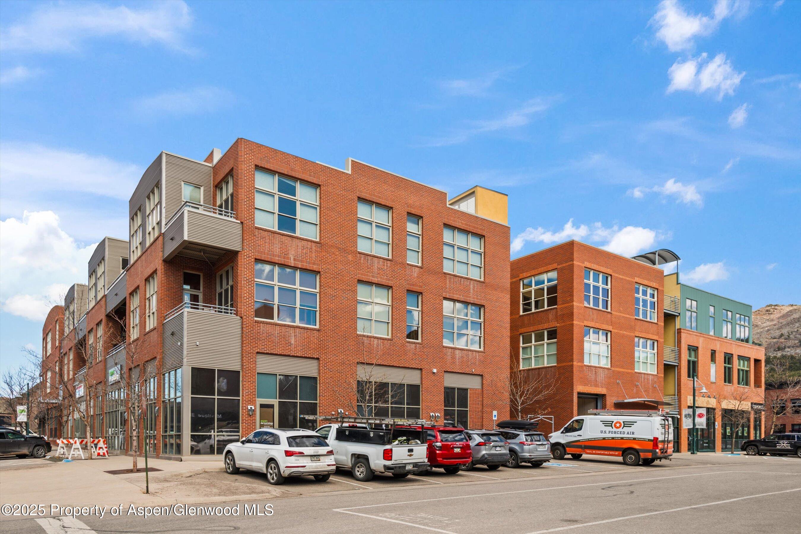 231 Robinson Street, Unit 338 Basalt, CO 81621 - Photo 5 of 17 a front view of a building with lot of cars and trees