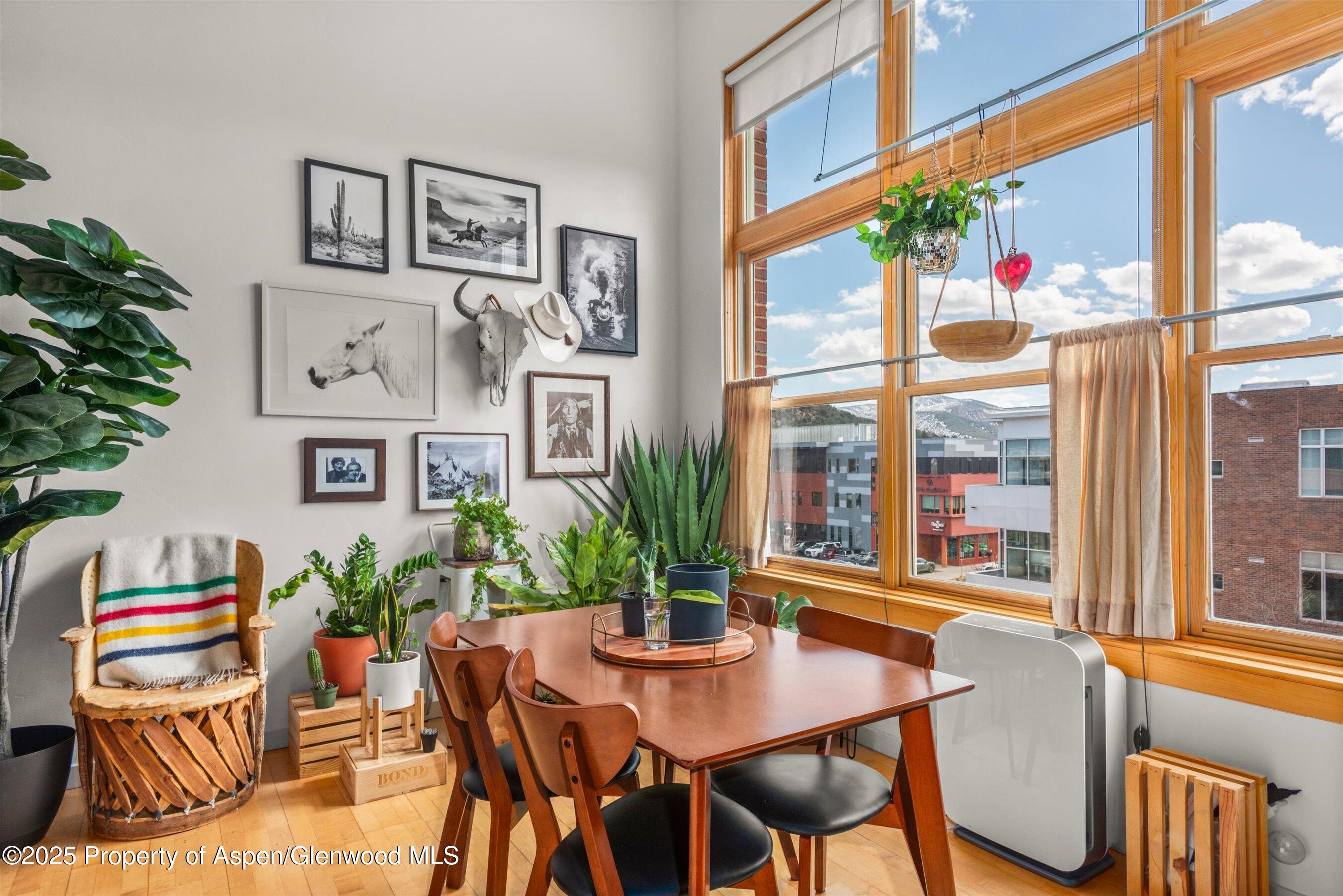 231 Robinson Street, Unit 338 Basalt, CO 81621 - Photo 6 of 17 a view of a dining room with furniture window and wooden floor