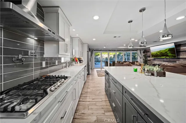 a view of a dining room with furniture wooden floor and a chandelier