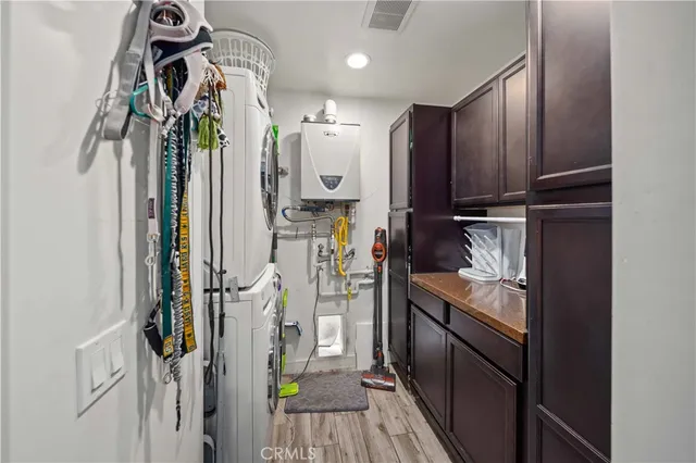 a kitchen with a table chairs a sink dishwasher window and cabinets