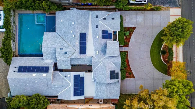 a kitchen with stainless steel appliances kitchen island granite countertop a table chairs sink and cabinets