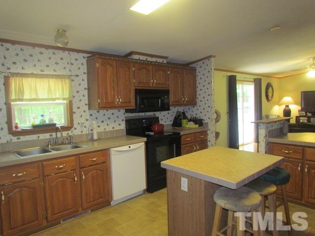 109 Medlin Road Rougemont, NC 27572 - Photo 12 of 19 a kitchen with a sink a stove cabinets and a dining room