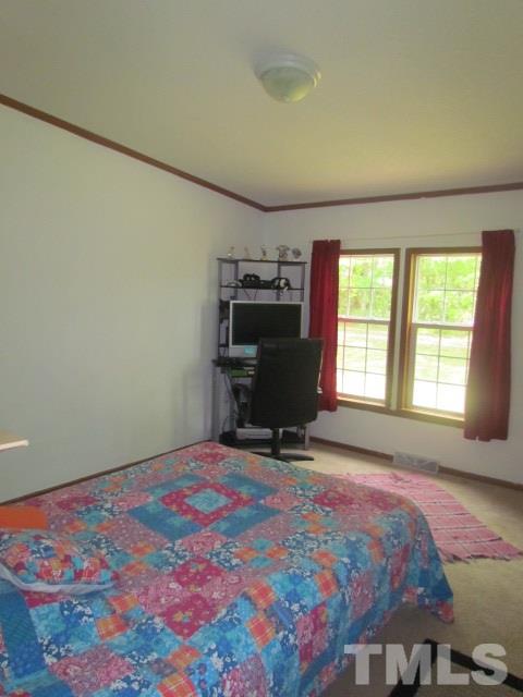 109 Medlin Road Rougemont, NC 27572 - Photo 17 of 19 a bedroom with a bed and large window