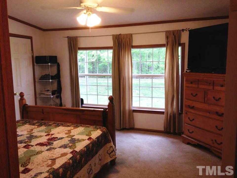 109 Medlin Road Rougemont, NC 27572 - Photo 4 of 19 a bed sitting in a room next to a window