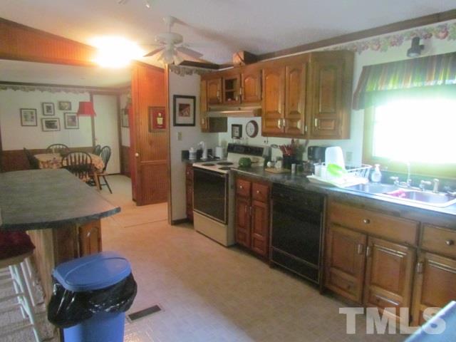 109 Medlin Road Rougemont, NC 27572 - Photo 5 of 19 a kitchen with a sink stove and cabinets