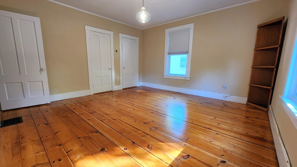 8 Fay Street, Unit 2 Westborough, MA 01581 - Photo 8 of 15 a view of empty room with wooden floor and fan