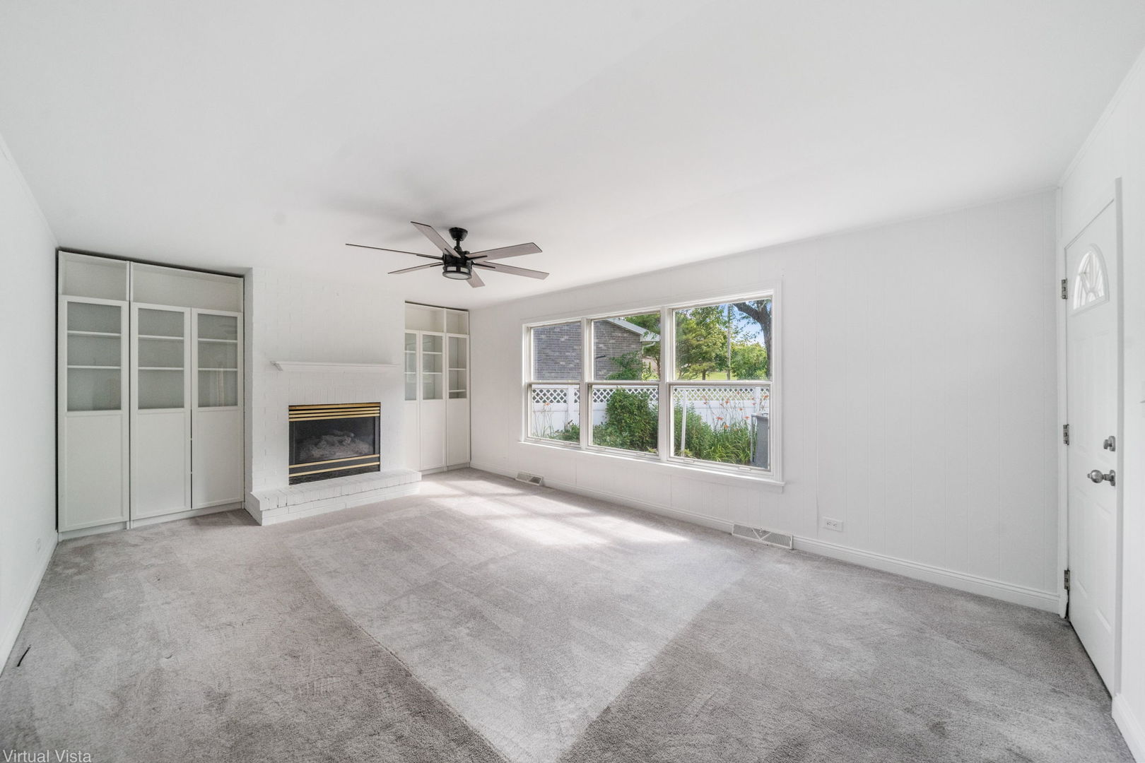 449 Ohio Road Frankfort, IL 60423 - Photo 11 of 25 a view of an empty room with a fireplace and a window
