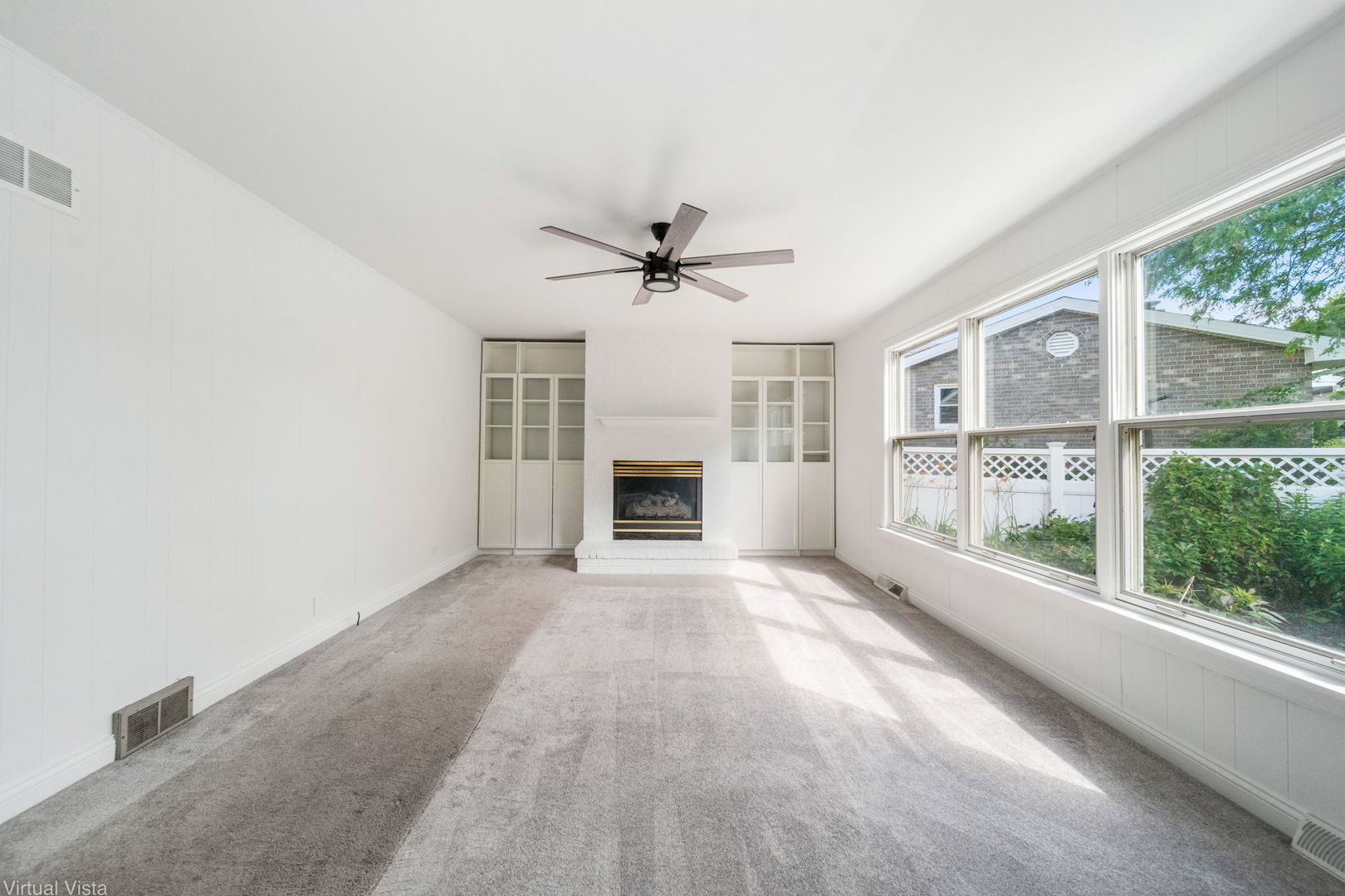 449 Ohio Road Frankfort, IL 60423 - Photo 12 of 25 en view of a livingroom with a fireplace a ceiling fan and windows