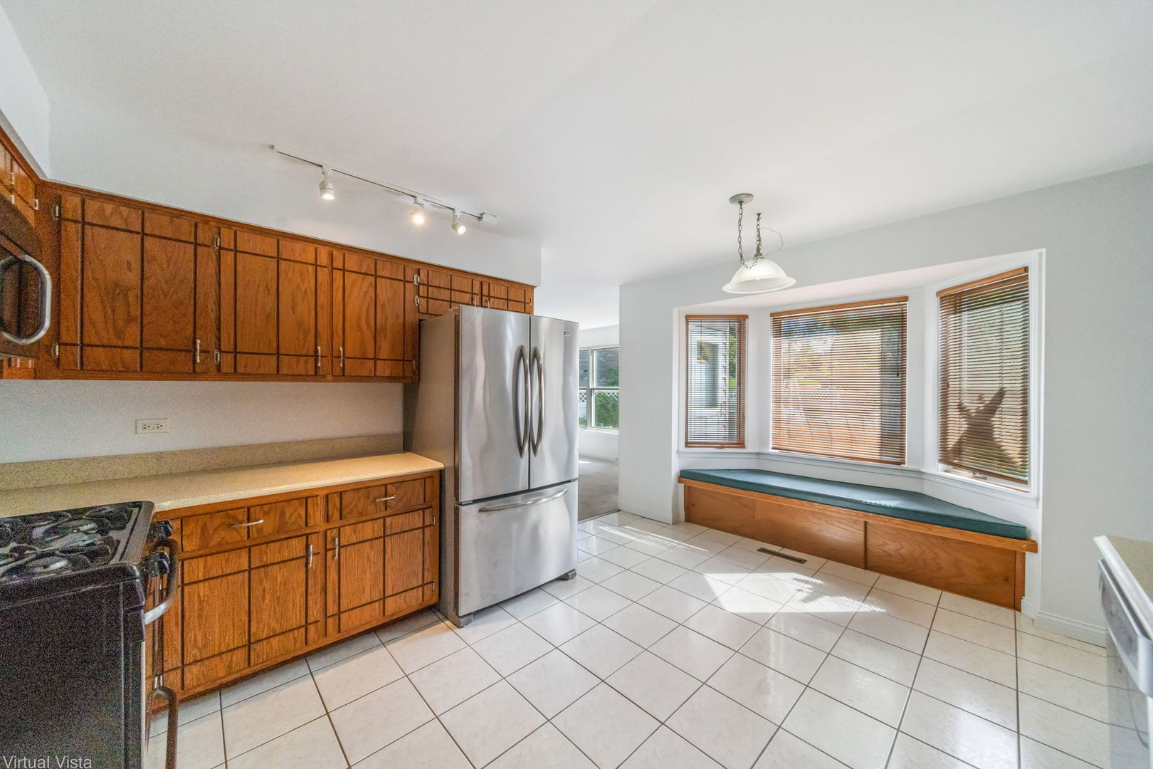 449 Ohio Road Frankfort, IL 60423 - Photo 7 of 25 a kitchen with granite countertop a refrigerator and a stove top oven
