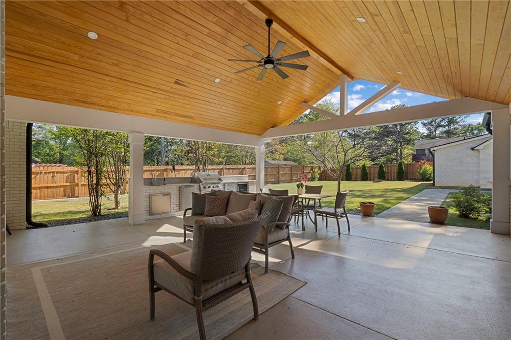 403 Rockbridge Road Southwest Lilburn, GA 30047 - Photo 54 of 77 a view of a patio with a table chairs and a small yard