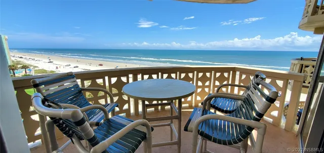 a balcony with table and chairs