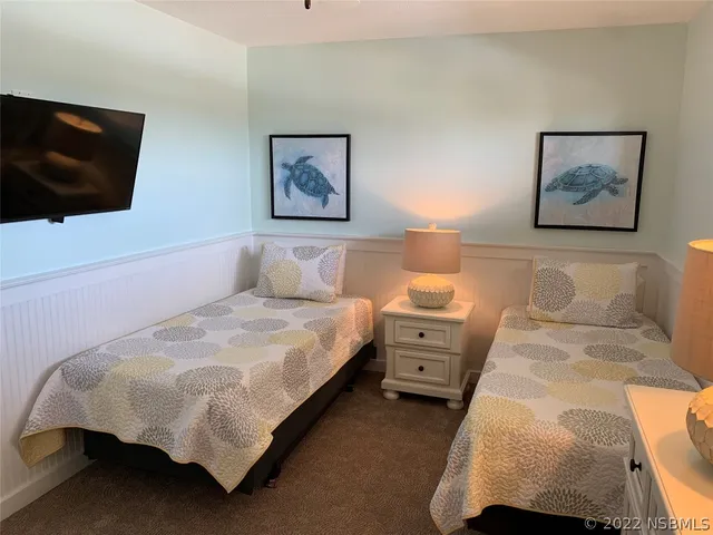 a kitchen with cabinets and a stainless steel refrigerator