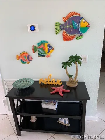 a living room with furniture a chandelier and a dining table