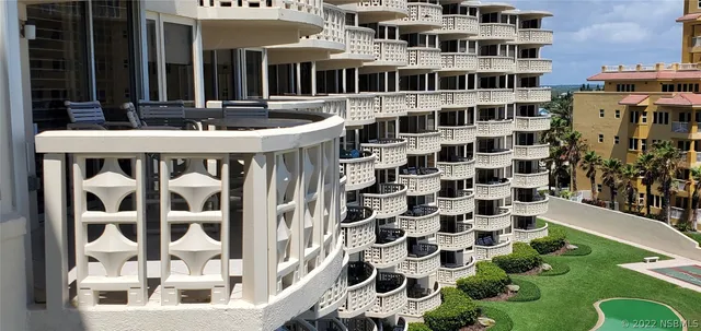 a front view of a building with a garden