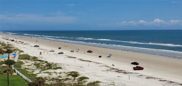 a bedroom with a bed and painting on the wall