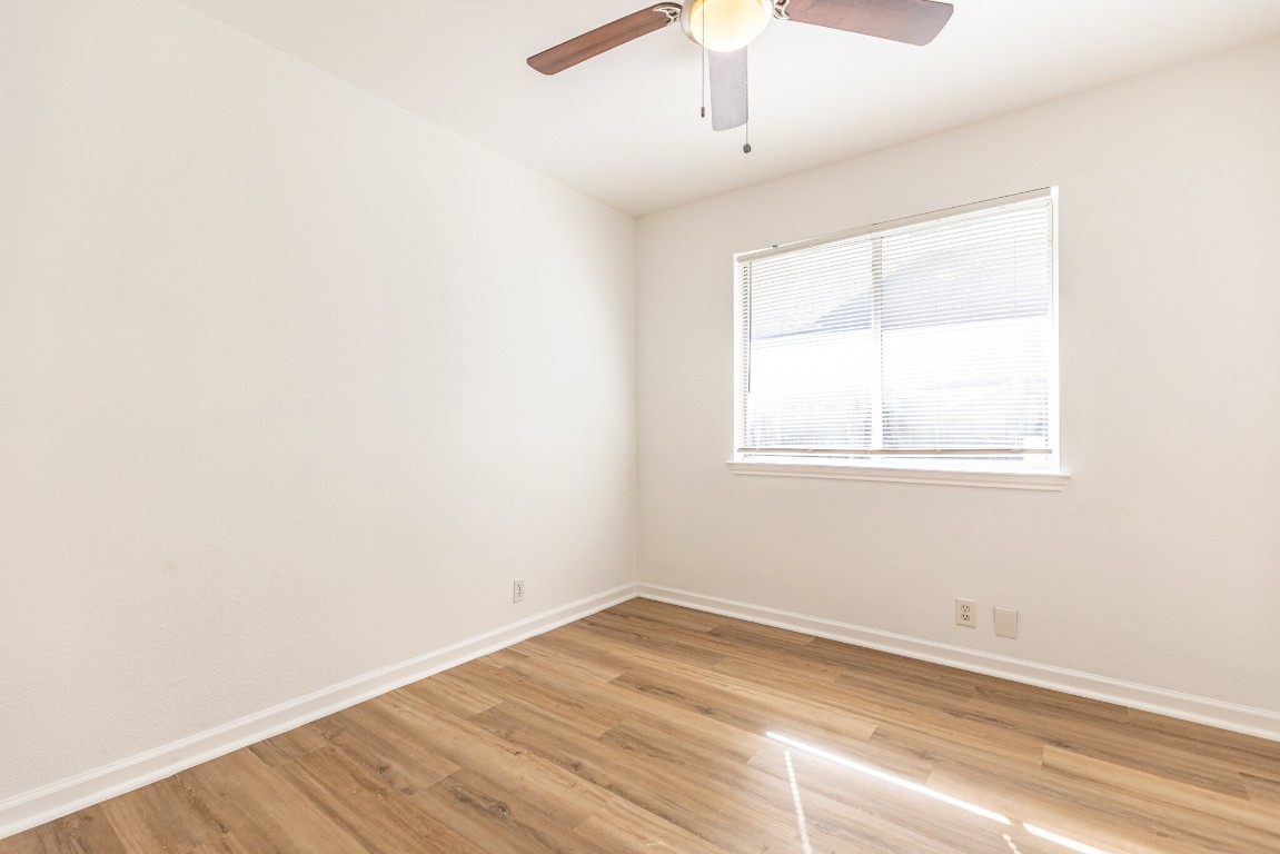 2012 Balsam Way Round Rock, TX 78665 - Photo 15 of 30 Unfurnished room featuring light wood-type flooring and a ceiling fan
