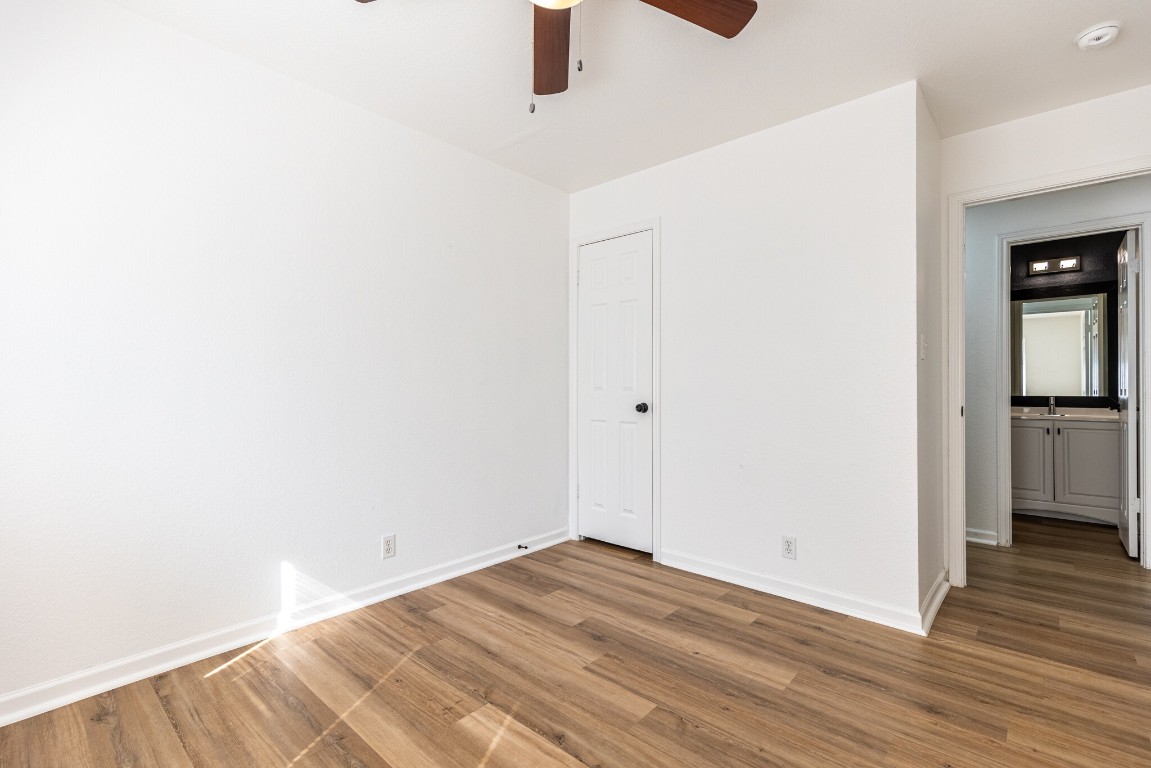 2012 Balsam Way Round Rock, TX 78665 - Photo 19 of 30 Unfurnished bedroom with wood finished floors and a ceiling fan