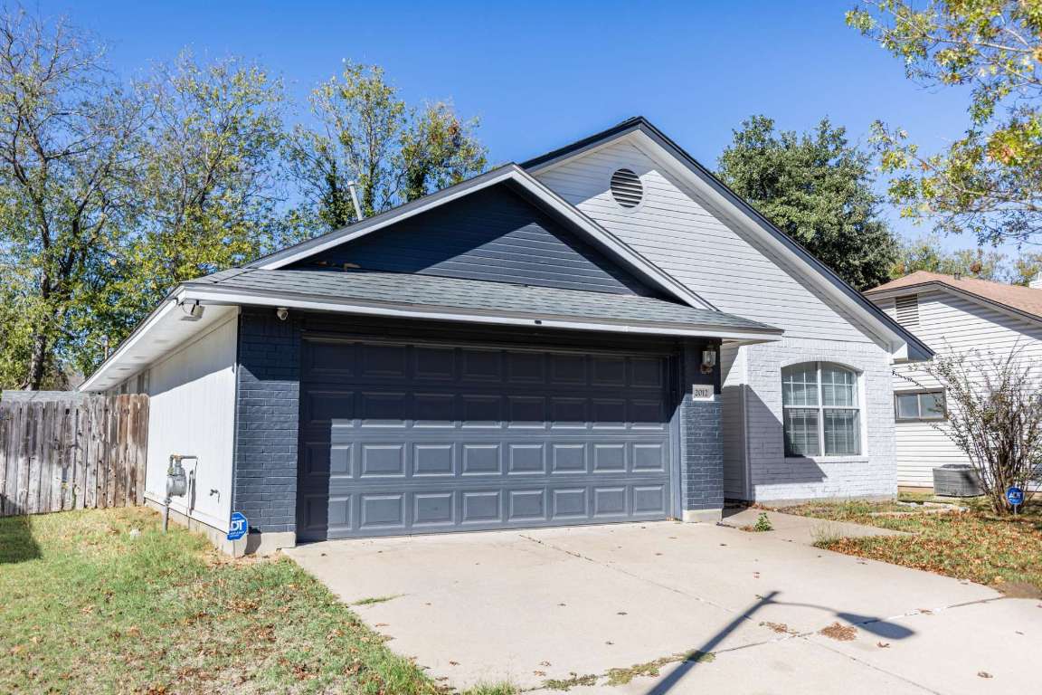 2012 Balsam Way Round Rock, TX 78665 - Photo 2 of 30 View of front of property featuring concrete driveway, brick siding, and a garage